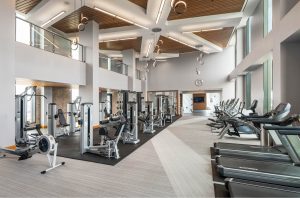 Penthouse-level fitness center with floor-to-ceiling windows and see-for-miles panoramas